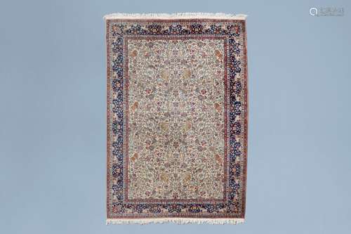 A large Persian Kerman rug with animals and floral design, w...