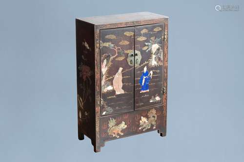 A Chinese lacquered and inlaid wooden two-door cabinet with ...