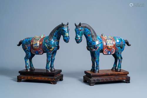 A pair of Chinese cloisonne horses on wooden bases, 20th C.