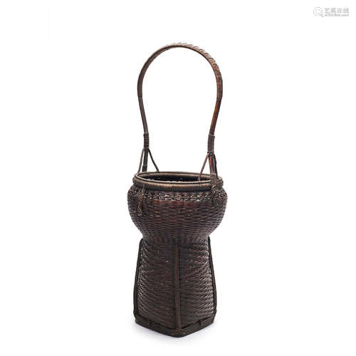 A tall handled bamboo basket