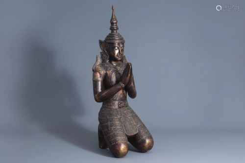 A patinated and gilt wooden kneeling Buddha figure,