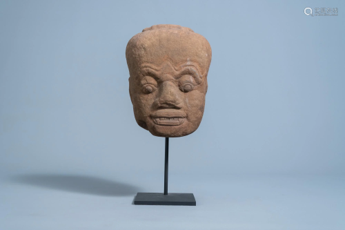 A Khmer sandstone head of a Dvarapala guardian figure,
