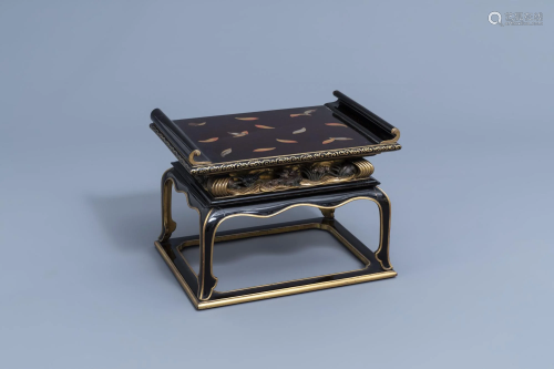 A Japanese gilt and lacquered wooden tray on stand with
