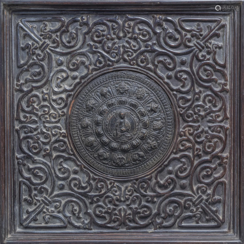 A Sino-Tibetan copper votive plaque in a carved wooden