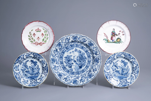 Two Dutch Delft blue and white plates and a charger and