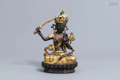 A Sino-Tibetan parcel-gilt bronze figure of Manjusri,