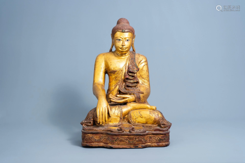 A tall inlaid gilt wood figure of a seated Buddha,