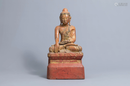 An inlaid partly gilt wood figure of a seated Buddha,