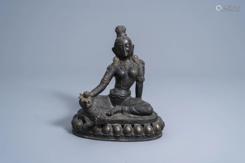 A Sino-Tibetan bronze figure of Tara holding a lotus,