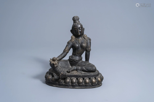 A Sino-Tibetan bronze figure of Tara holding a lotus,