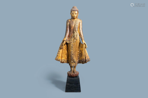 A tall inlaid gilt wood figure of a standing Buddha,