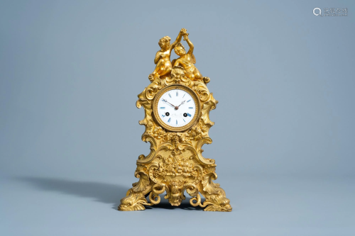A French gilt bronze mantel clock with bacchantes and