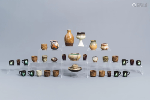 A varied collection of polychrome cups, bowls, jugs and