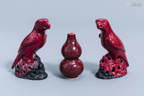 A pair of Chinese red glazed parrots and a monochrome