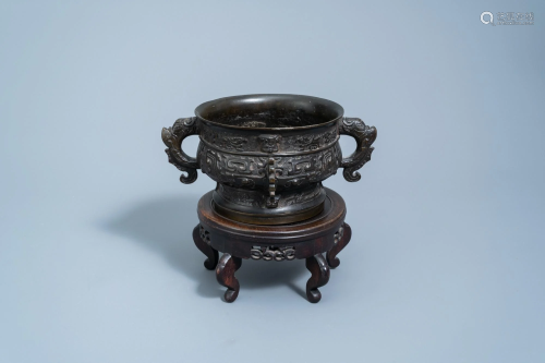 A Chinese bronze censer on wooden stand, Yuan/Ming