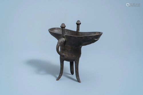 An inscribed Chinese bronze ritual wine vessel, 'jue',
