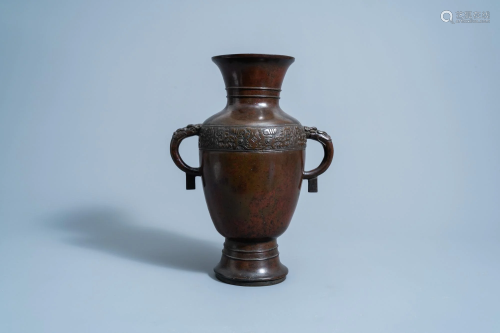 A Chinese archaic bronze vase with 'dragon' handles,