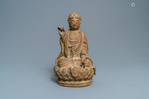 A Chinese sandstone figure of Buddha with traces of