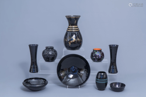 A varied collection of black glass vases and bowls,