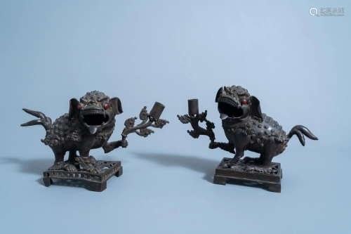A pair of Chinese bronze 'mythical beast' candlesticks,