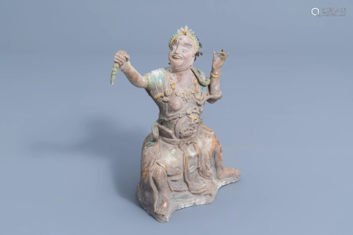 A Chinese partly glazed earthenware figure with a