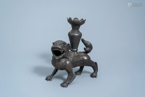 A Chinese bronze vase carried by a mythical animal,