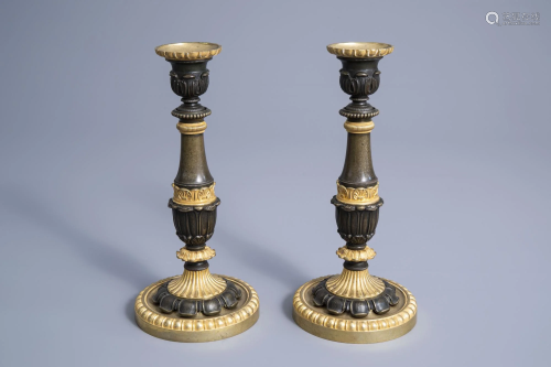 A pair of French gilt and patinated bronze candlesticks
