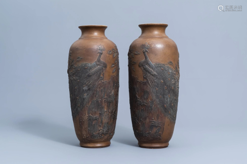 A pair of Chinese stoneware vases with a peacock on a