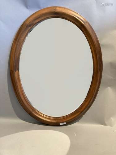 Miroir ovale en bois naturel mouluré. 76 x 60 cm.