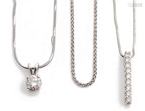 A contemporary single stone diamond set pendant