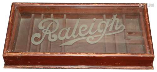 A vintage Raleigh Cycles wooden display cabinet,