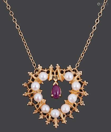 A 14K gold pearl and ruby heart shaped pendant