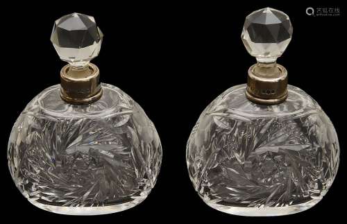 A pair of George V silver mounted cut glass scent bottles,