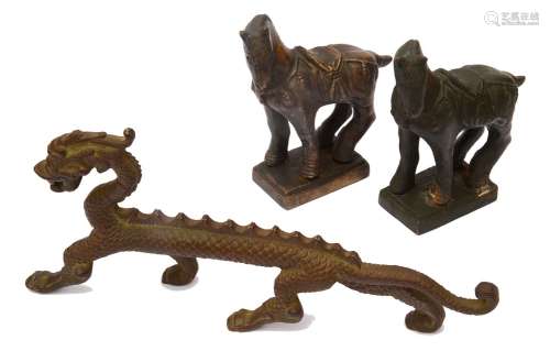 A Chinese bronze figure of a standing dragon and two Tang st...
