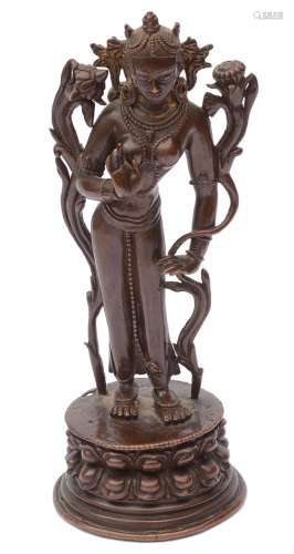 A Tibetan or Himalayan patinated bronze figure of Tara