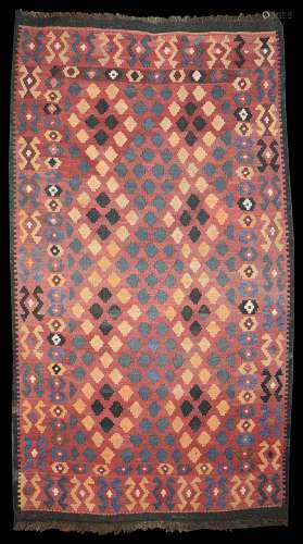 A Kelim rug red ground with a field of diamonds