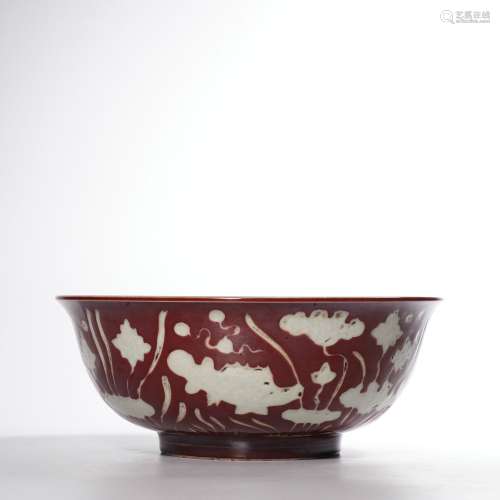 A red glazed 'fish and waterseeds' bowl
