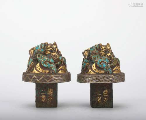 A pair of bronze beast ware with gold and silver