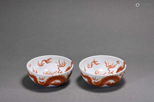 A pair of allite red glazed cup