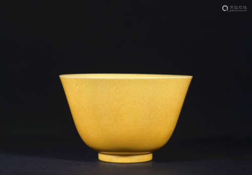 A yellow glazed cup