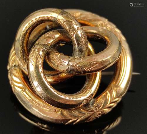 Brooch made of three intertwined circles, around them anothe...