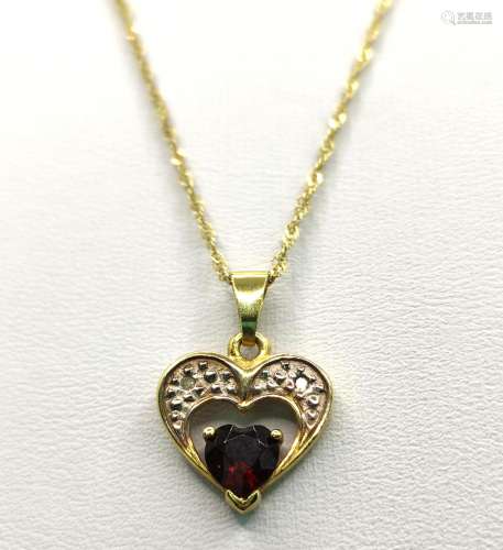 Heart pendant with garnet and two small diamonds, set in 585...