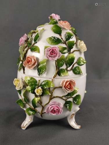 Porcelain egg, decorated with fully plastic roses and applie...