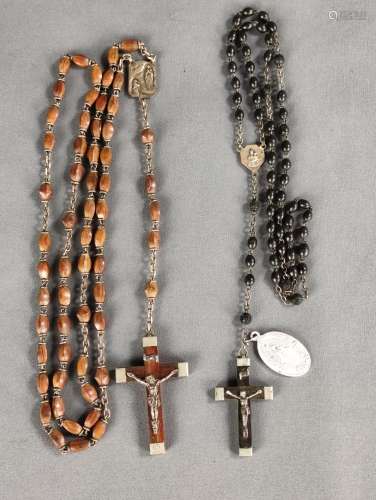 Two rosaries, wood and metal, l 54 cm and 37 cm, each in mat...