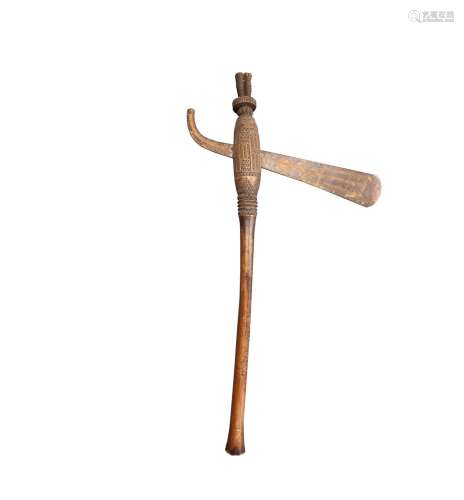 Sling iron attached to wooden handle, rounded and graphicall...