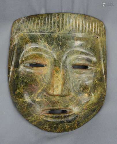 Stone mask, in the shape of a human head, flat nose, and a c...