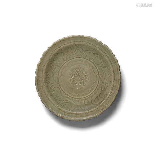 A molded and carved Longquan celadon 'peony' charger