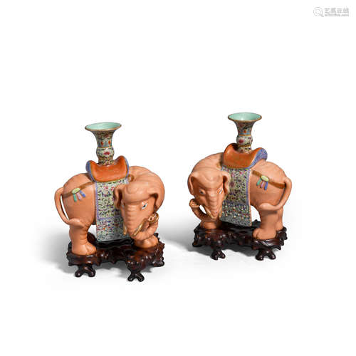 A pair of famille rose enameled porcelain candle holders