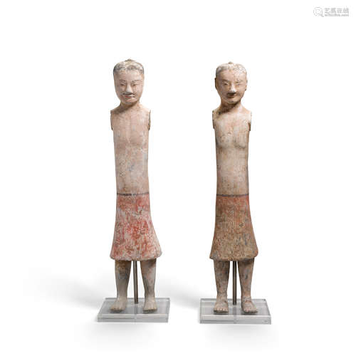 A PAIR OF PAINTED POTTERY  FIGURES OF ATTENDANTS