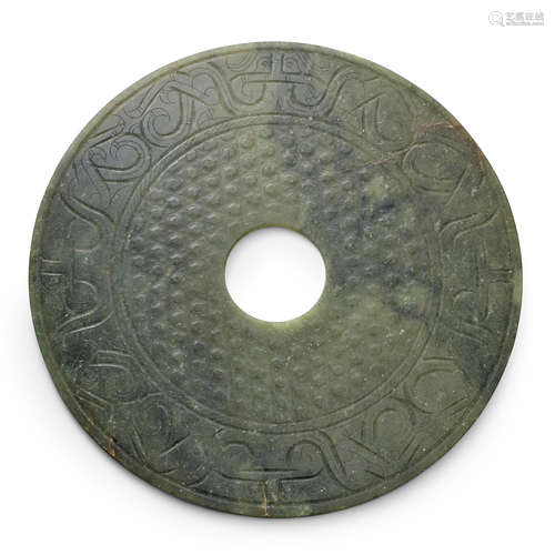 An elegant semi-translucent olive-green nephrite jade Disc, ...